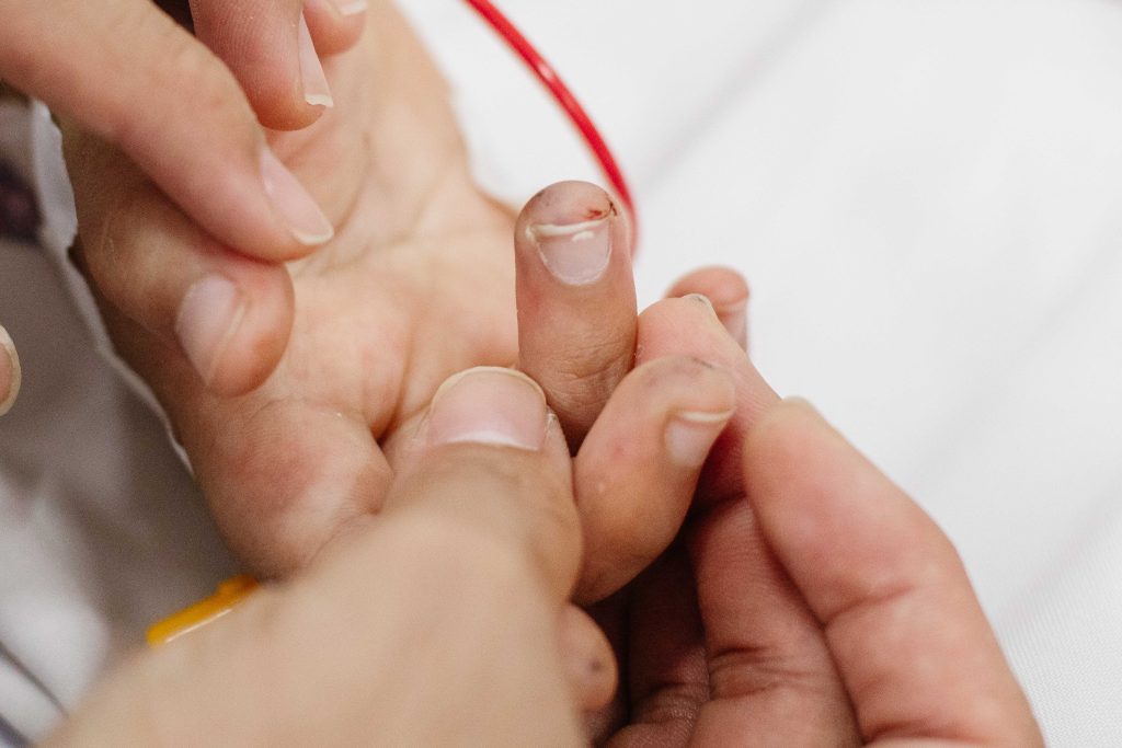 blood sample being taken from patient's finger