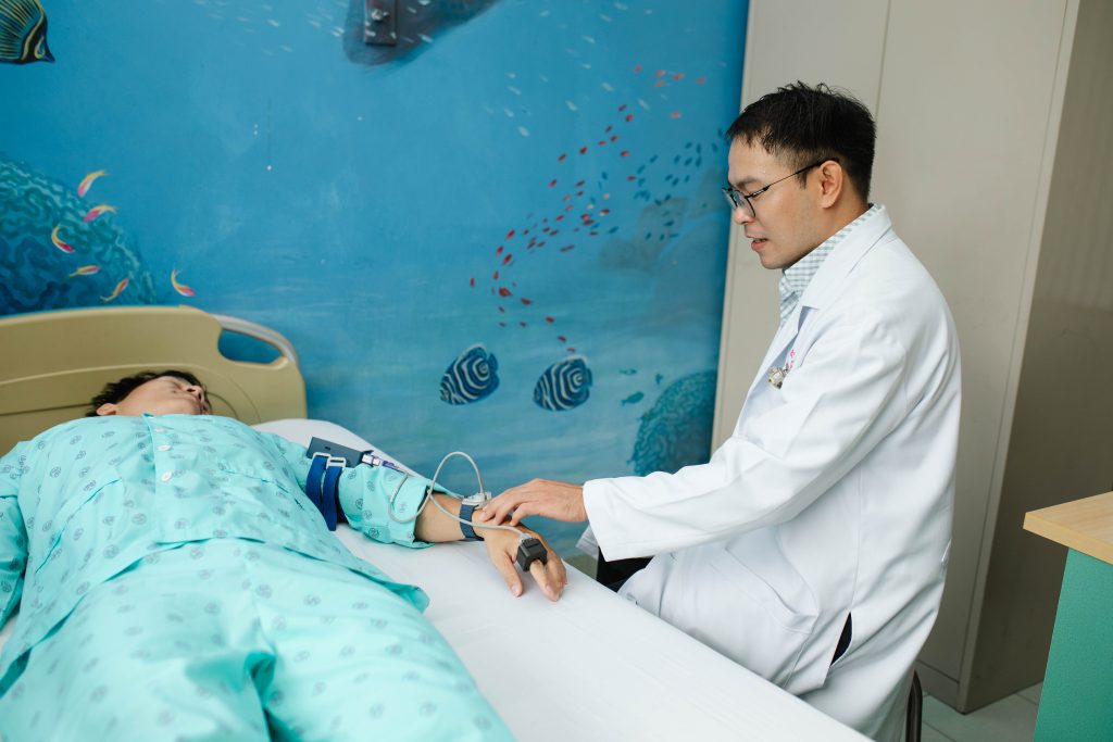 Clinician checking D-SCAPE on dengue patient in Hospital for Tropical Diseases