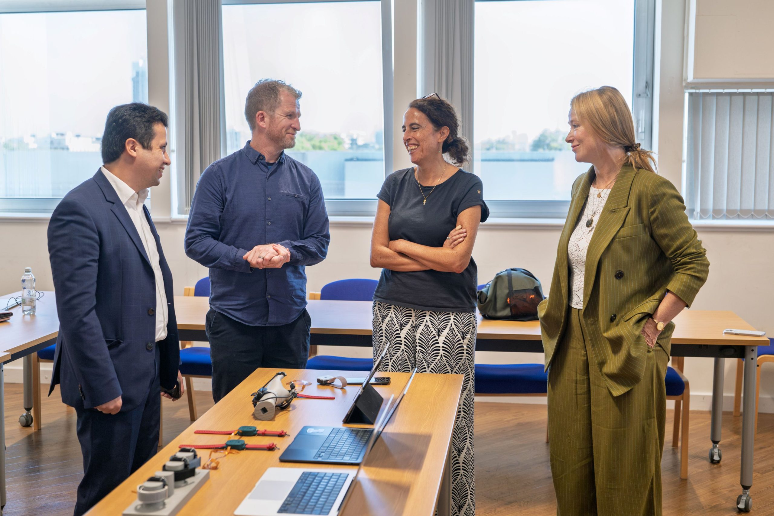 4 people talking with D-SCAPE prototypes in the foreground