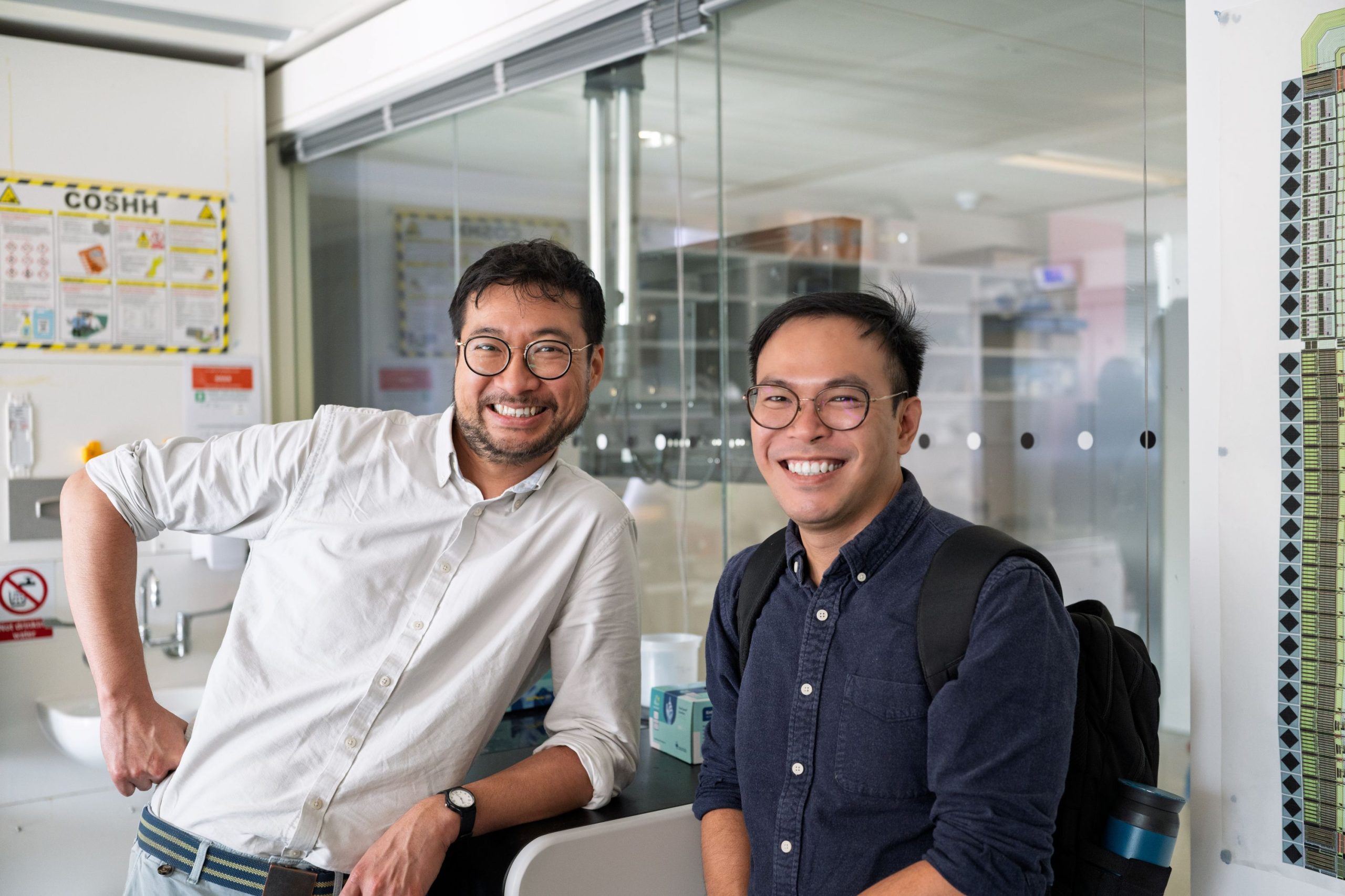 Two men smiling