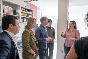 A woman talking to colleagues in a lab